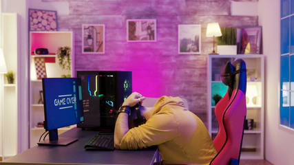 Successful man playing online video games on his computer © DC Studio