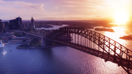 Aerial panoramic view of golden sunset over The Harbour Bridge in Sydney.