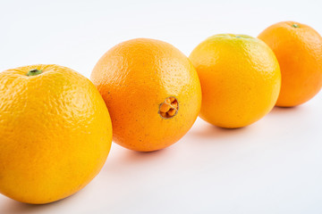 Row of fresh Gannan navel oranges on white background