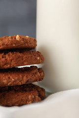 Chocolate crispy cookies with glass of milk close up