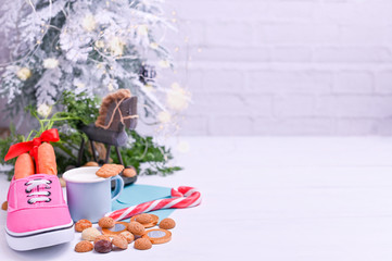 Traditional Dutch holiday for children Sinterklaas. Winter holidays in Europe and the Netherlands. background with pepernoten and traditional sweets strooigoed, Carrot in a boot and milk with cookies.