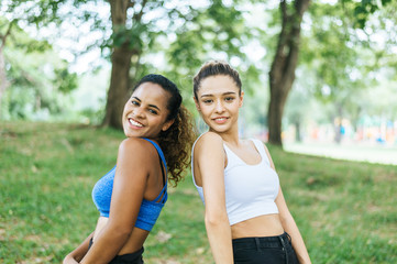 Young sporty woman standing and looking camera at public park together,Happy and smiling,Relaxing time