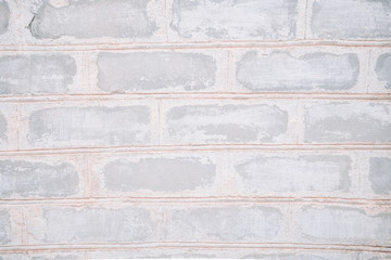 White old brick wall close-up with stitching. The texture of the stone masonry. Stone background for a subject shooting a flat lay. Concept of construction and interior design. Copy space