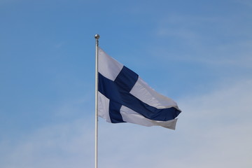 Flag of Finland blowing in the wind in Helsinki on holiday. Travelling with cruise ship in summer.