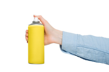 Yellow spray can for spraying in a female hand. No inscriptions. White background