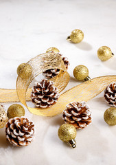 Fototapeta na wymiar Festive christmas ornaments on white table and gold ribbon