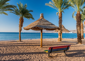 Morning on sandy public beach in Eilat- Israeli southernmost and famous tourist resort and recreational city, located on the northern shore of the Red Sea