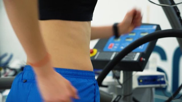 Professional racewalker woman on treadmill in gym sport lab
