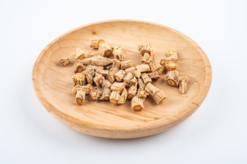 A pile of Chinese herbal medicine windbreak on white background