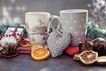People, Christmas, holidays concept. Christmas drink. Gray mug of hot tea, cocoa, coffee with marshmallows, oranges