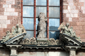 Fototapeta na wymiar Riga Latvia, Statues and detail over entrance of the Church of Saint Peter facade in the old town