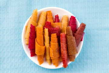 Pastilla, fruit rolls without sugar close-up on a blue cloth