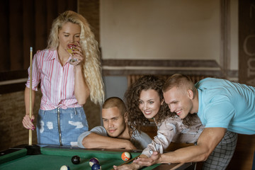 Naklejka premium Young people playing snooker at bar