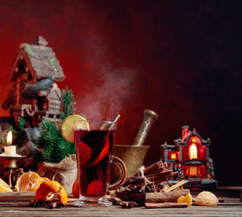 Mulled wine and Christmas decorations with candlesticks.