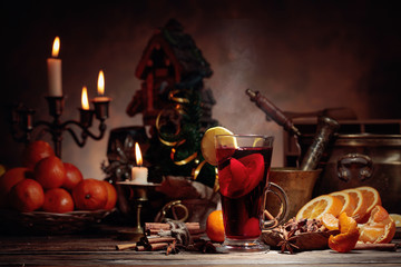 Mulled wine and Christmas decorations with candlesticks.