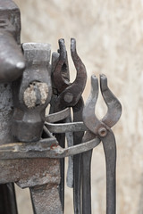 Pliers, tongs, hammer, anvil - blacksmith, metalsmith, farrier tools.
