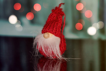 Red christmas gnome on an unfocused background
