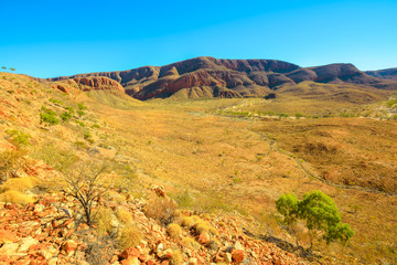 The vastness of Ormiston Gorge at lookout during the Ormiston Pound Walk in West MacDonnell Ranges. In the distance, Mount Sonder, one of highest mountains in Northern Territory, Australia Outback.
