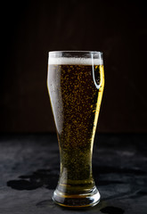 selective focus, a glass of lager with foam