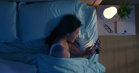 woman use smartphone on bed - Powered by Adobe
