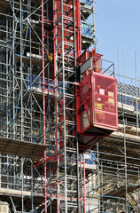 elevator at scaffold at tall construction site