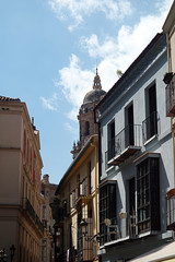 Downtown Malaga. Medieval streets that lead to the main focus of the ancient city, the Cathedral.  In the distance, above the rooftops, is the north tower of that fine building.