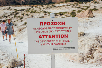 Attention sign near a descent to Nisyros volcano crater.