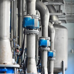 Large industrial water treatment and boiler room. Piping, servo butterly vlaves, flanges, pressure...