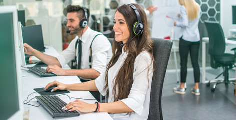 Friendly customer support service agents working in office