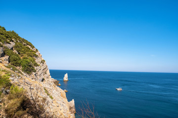 Fototapeta na wymiar A high steep rocky coast on the southern coast of Crimea.