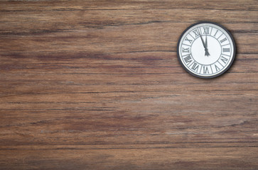 Old Clock close to midnight on vintage wood background. New Year's and Christmas holiday concept