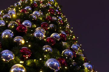 Close-up of a Christmas tree decorated with christmas tree toys and garlands
