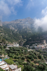 Fototapeta na wymiar Colorful village Positano at the foot of foggy Monte San Michele in Amalfi Coast, Italy