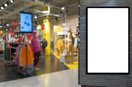 blank showcase billboard or advertising light box for your text message or media content with  blurred image popular fashion clothes shop showcase in shopping mall, commercial, marketing concept