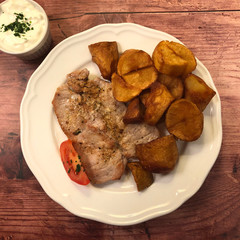 Sautéed Pork Cutlets with fried potatoes .