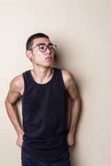 Young sexy man in glasses posing and looking at camera