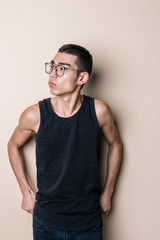 Young sexy man in glasses posing and looking at camera