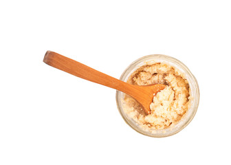 Horseradish sauce in a glass jar with wooden spoon