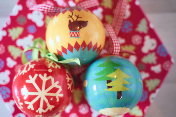 Fototapeta na wymiar Christmas tree balls on wooden background seen from above