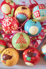 Fototapeta na wymiar Christmas tree balls on wooden background seen from above