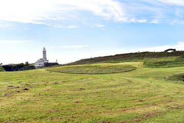 Fototapeta na wymiar Cabo Mayor Park on a sunny day and Lighthouse of Cabo Mayor at the background, Santander, Cantabria, Spain