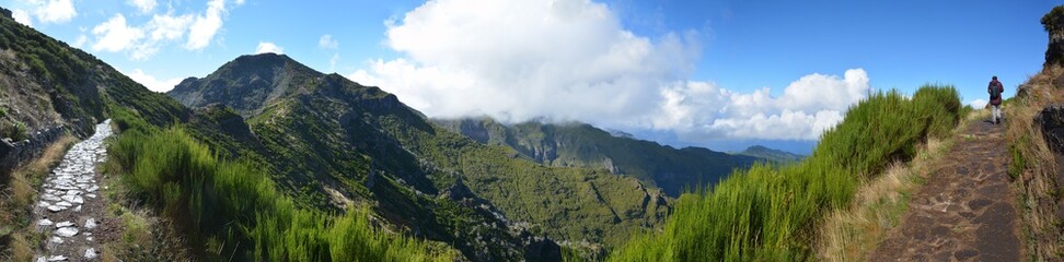 Wide panoramic view of Madeira island. Pathway with woman walking. 180 degree photography