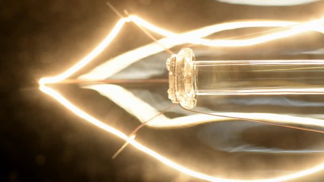 Close up shot of an halogen lamp turing on and off.