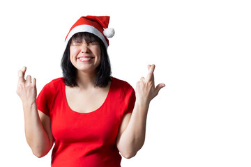 Fototapeta na wymiar young woman in red santa hat closed eyes making wish cross fingers at good luck