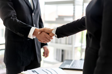 Business men Shaking Hands and Smiling with business women women after agreeing to work together in office.