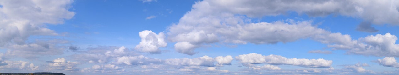 Naklejka na ściany i meble September is the autumn sky. White aerial clouds on a blue sky, panoramic photo.
