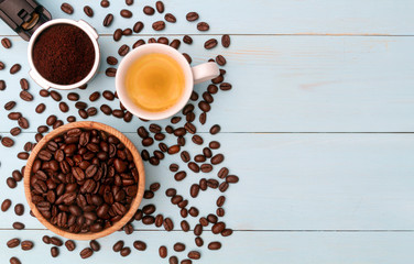 Cup of espresso coffee on a wooden table with coffee beans and ground coffee on a light background. Top view.Copy space.