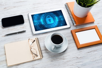 Web security and technology concept with tablet pc on wooden table