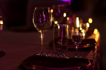 wine glasses on table on dark background. Wine glasses and grapes on stone table