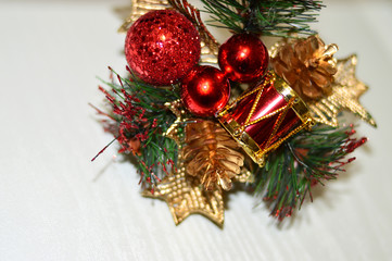 Christmas decor on a light background. Gold star, additional decorations, Christmas toys, tree branches